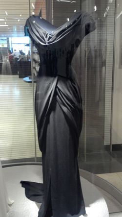 Black silk evening gown by Walter Plunkett, worn by Hepburn as Amanda Bonner in Adam's Rib [MGM, 1949]; Kent State University Museum, KSUM 2010.12.4, Gift of the Estate of Katharine Hepburn. Designed to accent her 20" waist, this gown was colored red by the MGM publicity department for the lobby card, right.